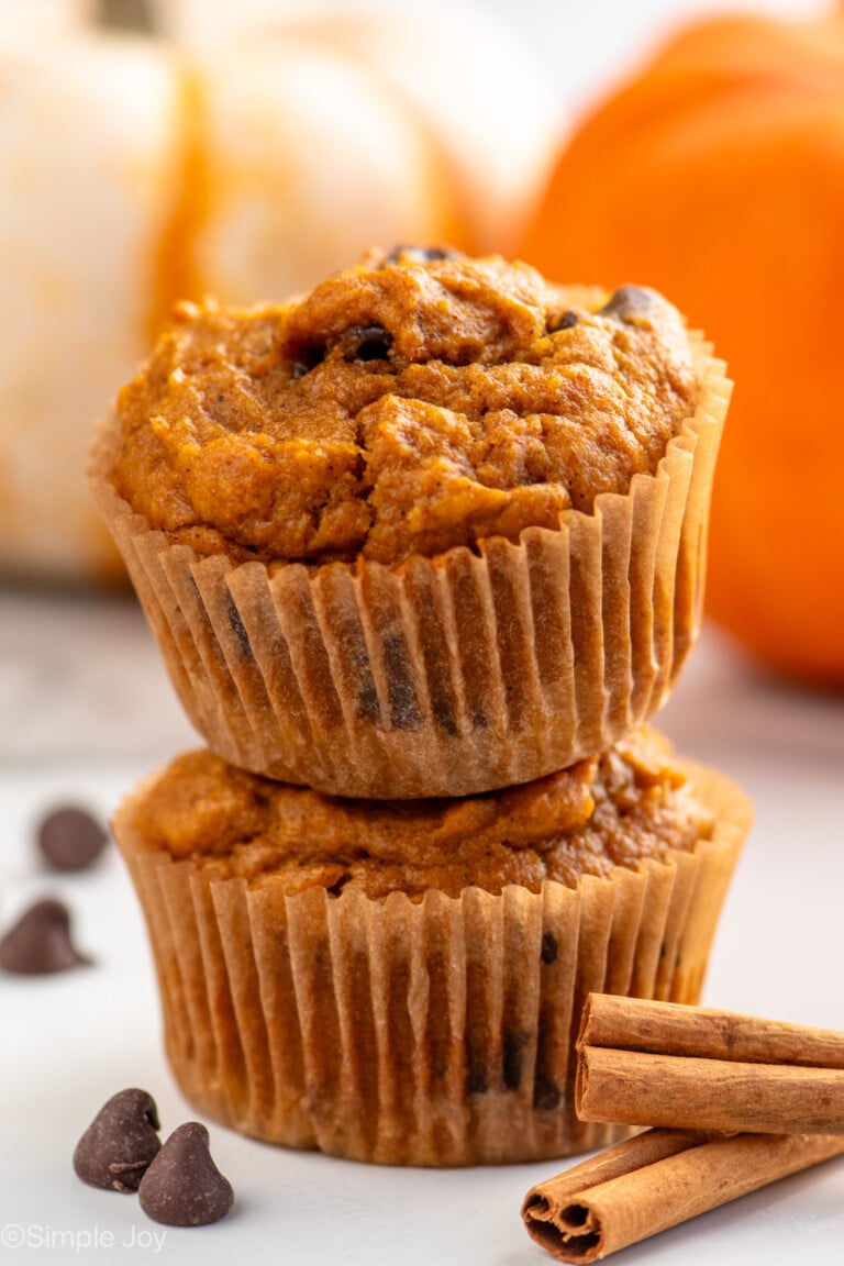 two pumpkin chocolate chip muffins stacked on top of each other