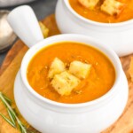 Photo of two bowls of Pumpkin Soup garnished with croutons