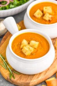 Photo of two bowls of Pumpkin Soup garnished with croutons