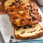 Pinterest graphic for Chocolate Chip Bread recipe. Image shows partially sliced loaf of Chocolate Chip Bread with cups of coffee beside. Text says, "Chocolate Chip Bread simplejoy.com"