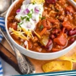 Pinterest graphic for Turkey Chili recipe. Image is photo of two bowls of Turkey Chili. Spoon and chips beside. Text says, "Turkey Chili simplejoy.com"