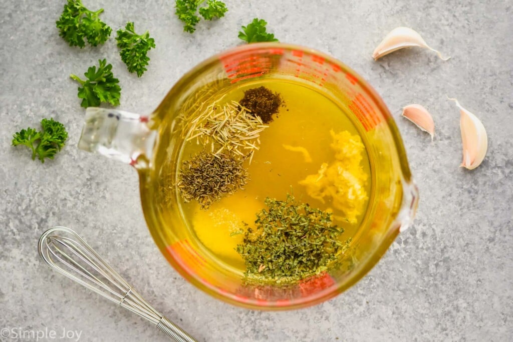 Overhead photo of a measuring cup of ingredients for Baked Chicken Thighs recipe