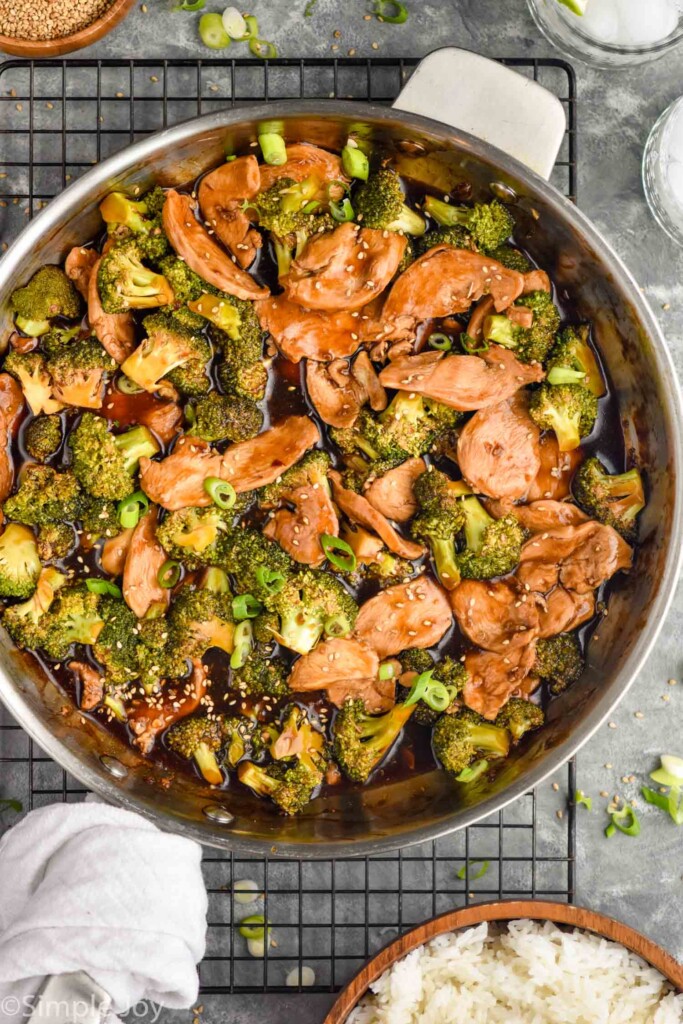 Overhead photo of a skillet of Chicken and Broccoli Recipe with a bowl of rice beside