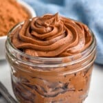 glass jar of chocolate frosting with measuring spoons - 17