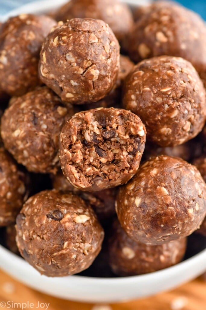 close up photo of Chocolate No Bake Energy Bites with a bite taken out of one of the Chocolate No Bake Energy Bites