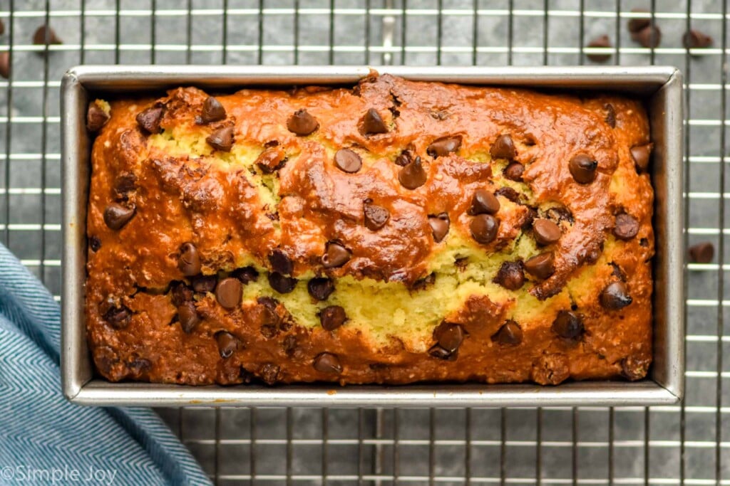 Overhead photo of a pan of Chocolate Chip Bread on a cooling rack