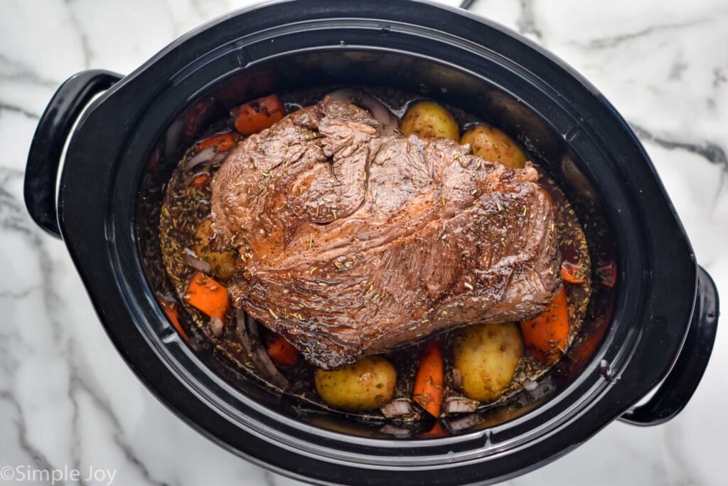 Overhead photo of a crock pot of Slow Cooker Pot Roast