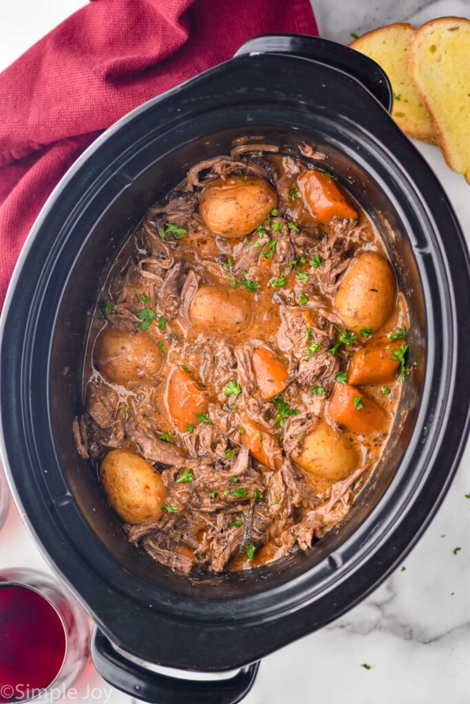 Overhead photo of a crock pot of Slow Cooker Pot Roast recipe.