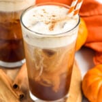 Photo of Pumpkin Cream Cold Brew with cinnamon sticks and pumpkin beside