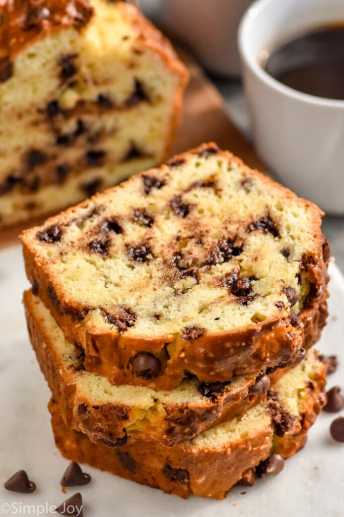 Stack of slices of Chocolate Chip Bread with loaf of bread and cup of coffee beside
