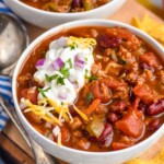 Photo of two bowls of Turkey Chili. Chips and spoon beside.