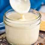 jar of White Pizza Sauce with a spoon coming out of jar