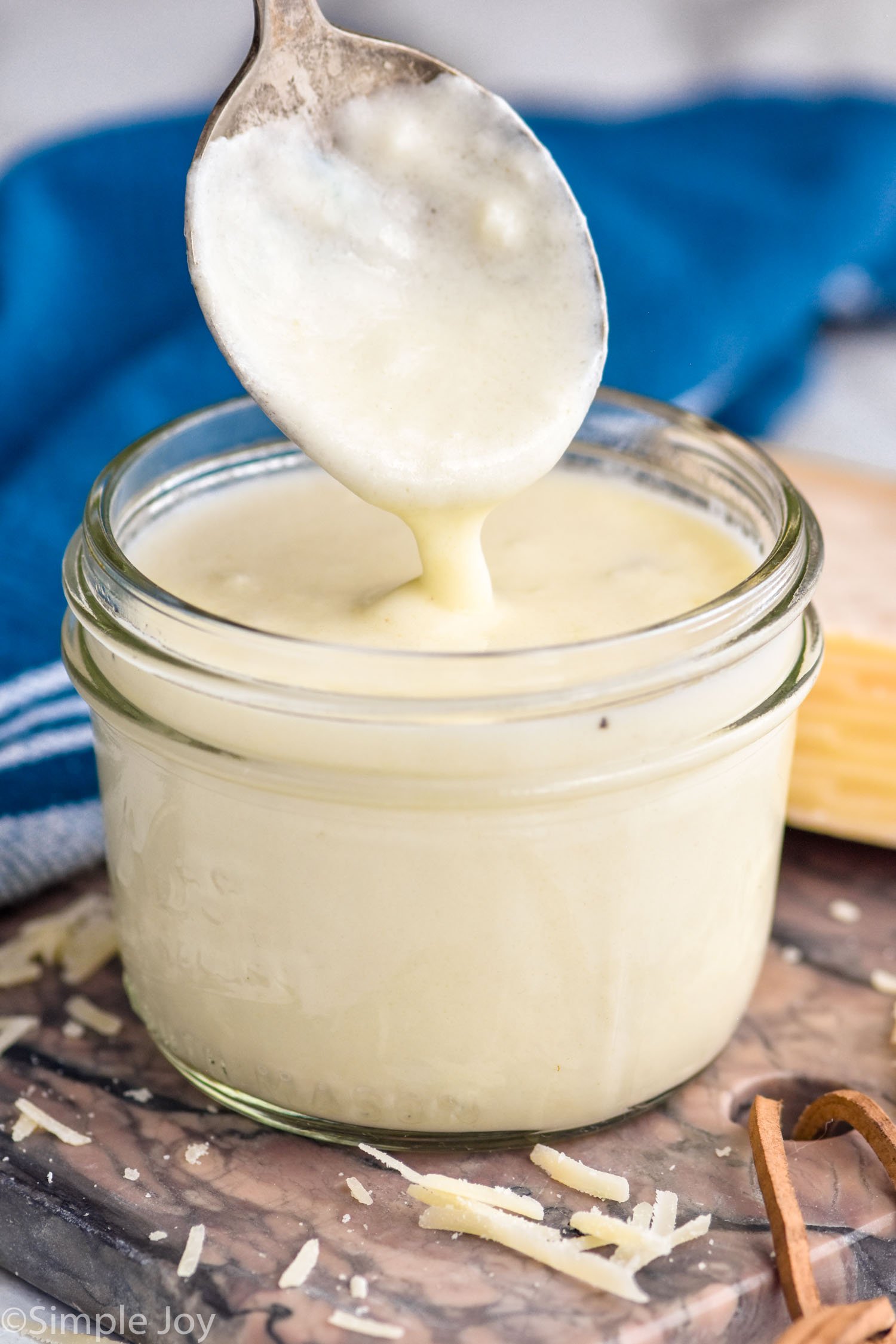 jar of White Pizza Sauce with a spoon coming out of jar
