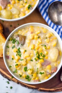Overhead photo of bowl of Crockpot Corn Chowder with spoon beside