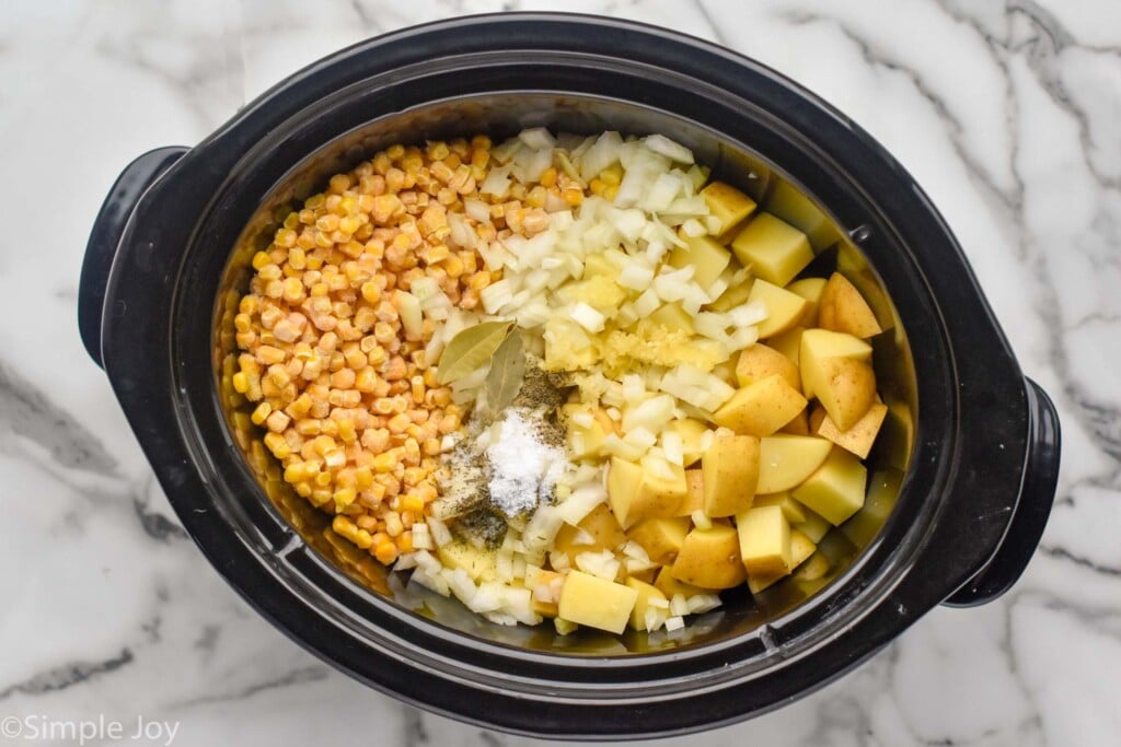 Overhead photo of a crock pot of ingredients for Crockpot Corn Chowder recipe