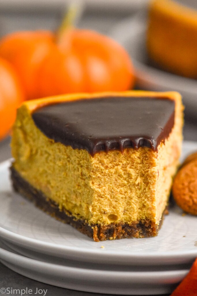 Side view of a slice of Pumpkin Cheesecake with a bite taken out.