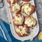 Pinterest graphic for Smashed Potatoes. Image shows overhead of Smashed Potatoes on a plate. Text says "amazing smashed potatoes simplejoy.com"