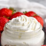 Pinterest graphic for Homemade Whipped Cream recipe. Text says, "the best whipped cream simplejoy.com." Image shows a jar of Homemade Whipped Cream with strawberries beside.