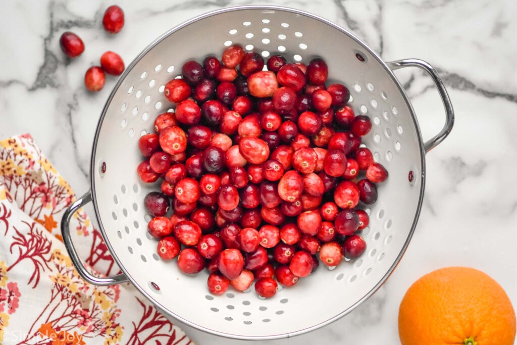 overhead of strainer of fresh cranberries to make cranberry sauce