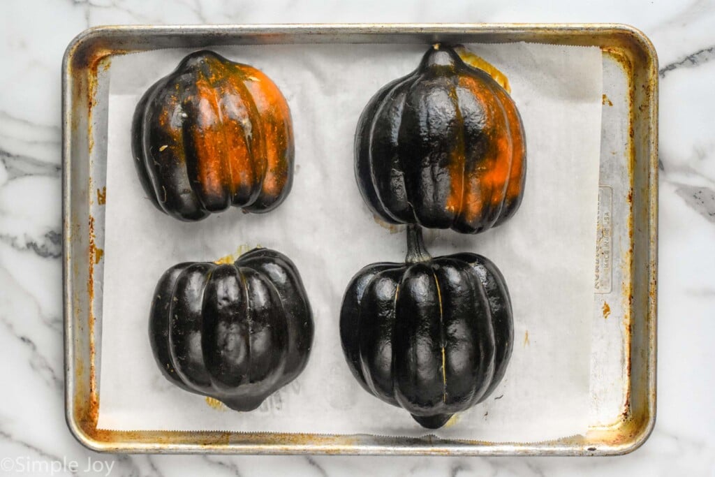 overhead of how to cook acorn squash on a baking sheet