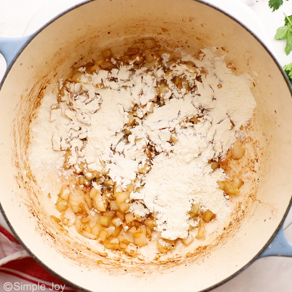 onions added to cooked onion in a pot