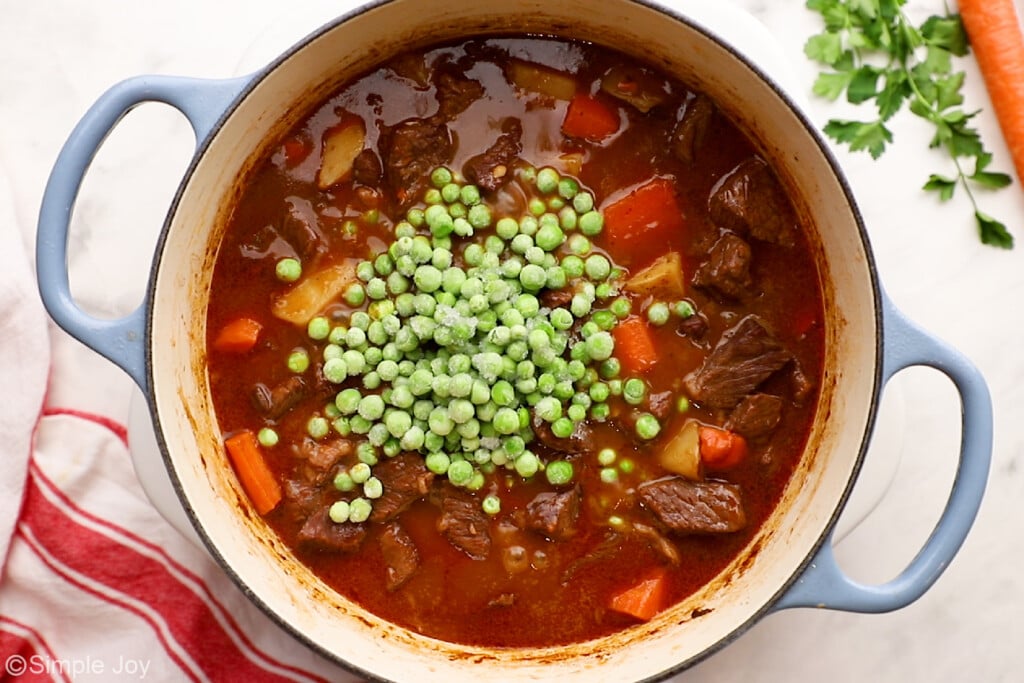 beef stew with frozen peas added to it