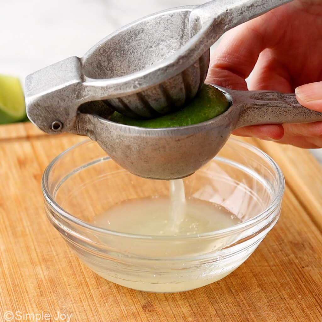 juicing a lime into a small bowl