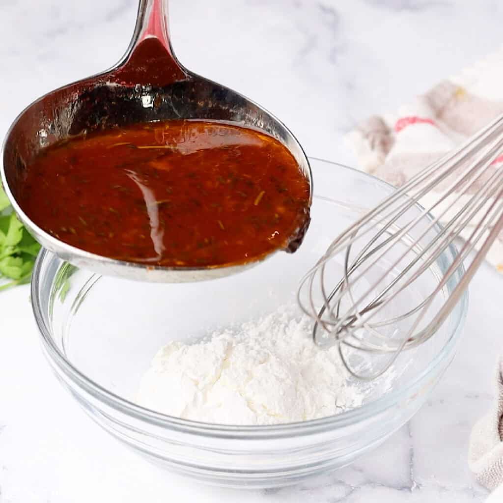 broth from a crockpot pot roast being added to cornstarch