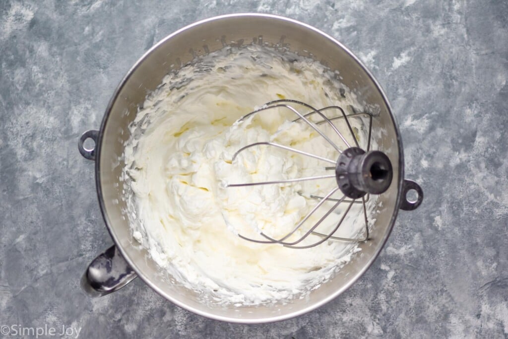 Overhead photo of a mixing bowl with Homemade Whipped Cream and beater