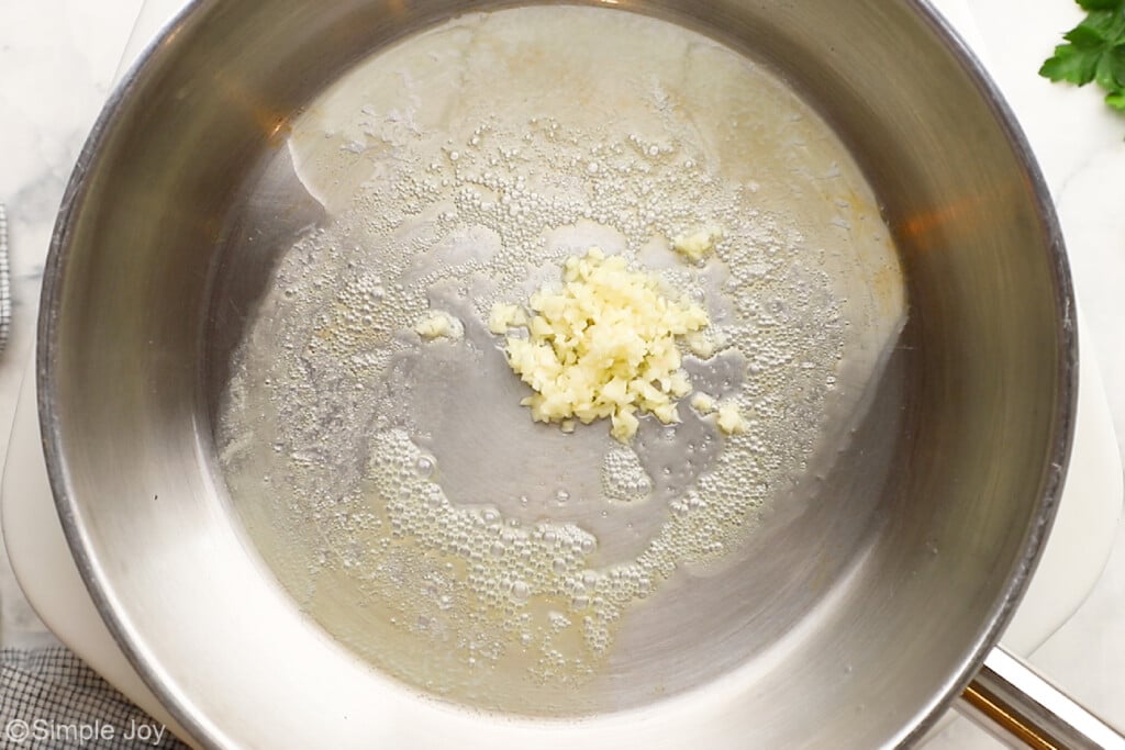 overhead picture of a garlic being sauteed in butter