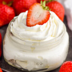 Photo of a jar of Homemade Whipped Cream with strawberries
