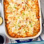 Pinterest graphic for Baked Ziti recipe. Overhead photo of a baking dish of Baked Ziti on a cooling rack. Text says, "baked ziti simplejoy.com"