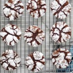 Pinterest graphic for Chocolate Crinkle Cookies recipe. Overhead photo of Chocolate Crinkle Cookies on a cooling rack. Text says, "delicious crinkle cookies simplejoy.com"