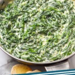 Pinterest graphic for Creamed Spinach recipe. Image shows a pan of Creamed Spinach with bread beside. Text says, "Creamed Spinach simplejoy.com."