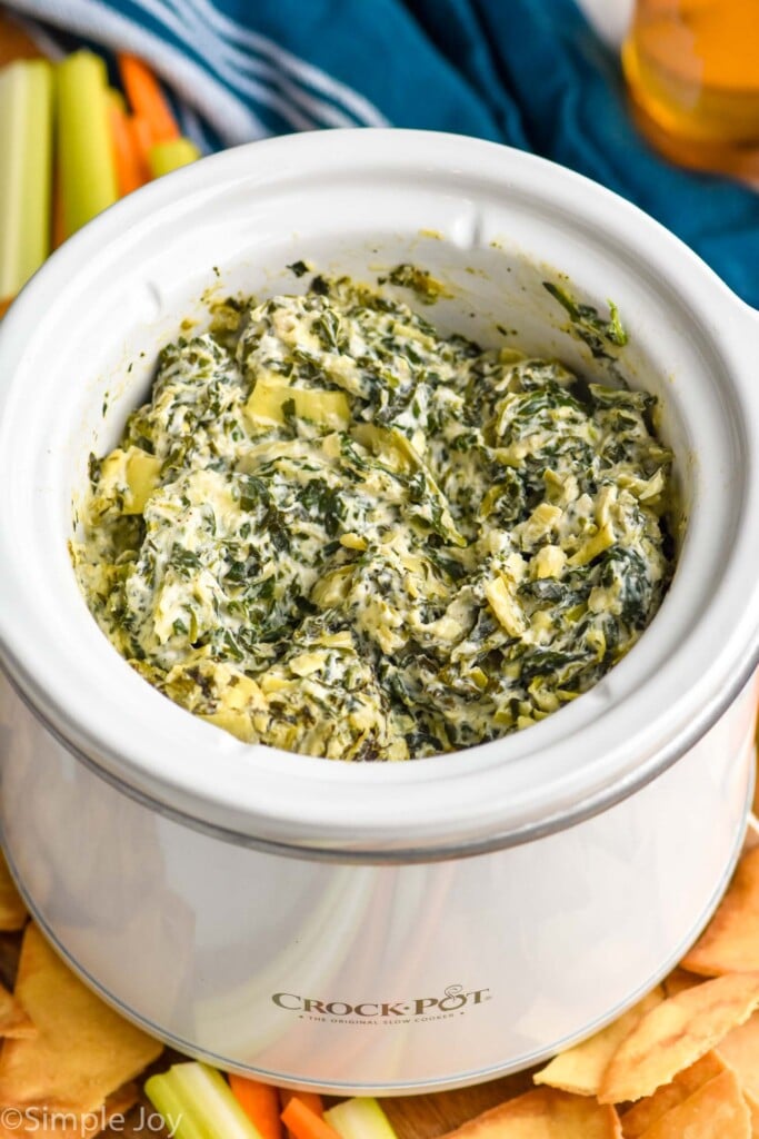 Photo of Crockpot Spinach Artichoke Dip with chips beside