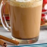 Pinterest graphic for Eggnog Latte recipe. Photo is side view of mug of Eggnog Latte garnished with whipped cream. Cinnamon sticks beside. Text says, "Eggnog Latte simplejoy.com"