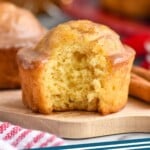 Pinterest graphic for Eggnog Muffins recipe. Image shows a side view of Eggnog Muffin with a bite taken out. Text says, "Eggnog Muffins simplejoy.com"