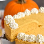 Pinterest graphic for No Bake Pumpkin Cheesecake recipe. Text says, "No Bake Pumpkin Cheesecake simplejoy.com." Image shows a slice of No Bake Pumpkin Cheesecake being served from No Bake Pumpkin Cheesecake. Pumpkin beside.