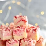 Pinterest graphic for peppermint fudge. Text says "the best candy cane fudge simplejoy.com" Image shows a plate of peppermint fudge