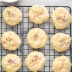 Pinterest graphic for ricotta cookies. Text says "the best ricotta cookies simplejoy.com" Image shows overhead of ricotta cookies on a cooling rack.