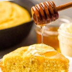 Pinterest graphic for Skillet Cornbread recipe. Text says, "amazing Skillet Cornbread simplejoy.com." Image shows honey being drizzled onto a slice of Skillet Cornbread.
