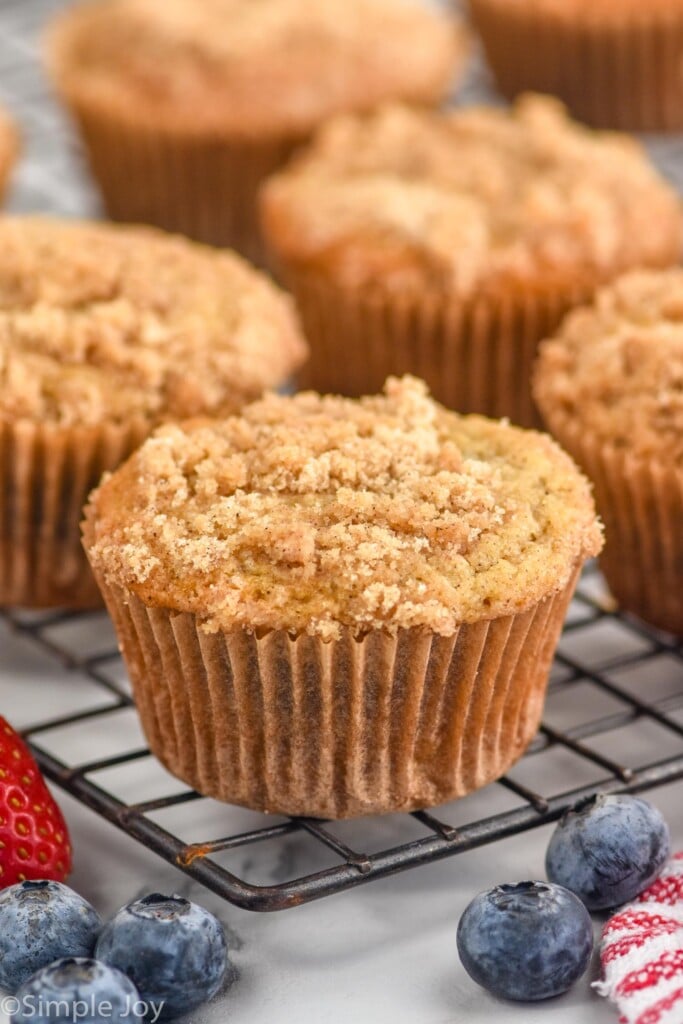 Coffee Cake Muffins on cooling rack, berries beside.