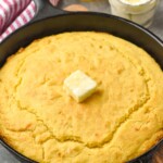 Skillet Cornbread with butter. Butter and honey beside.
