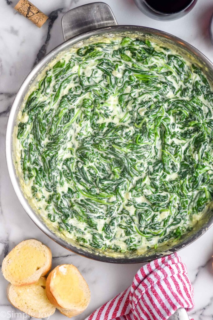 Pan of Creamed Spinach with bread beside