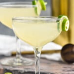 two glasses of daiquiri cocktails garnished with a lime twist - 8