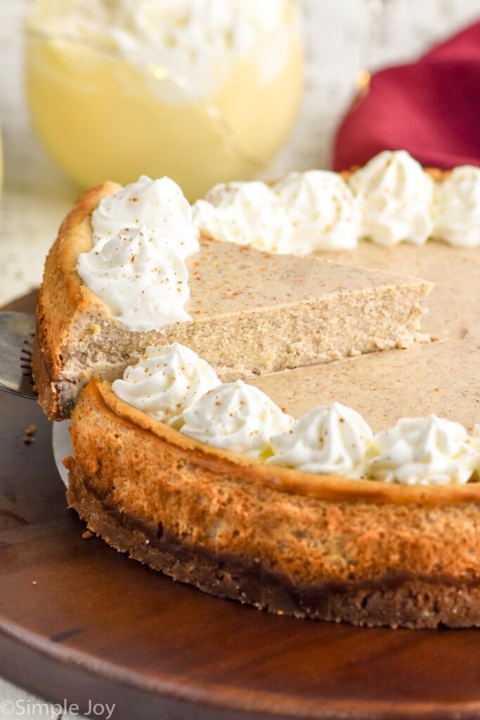 Slice of Eggnog Cheesecake being lifted from Eggnog Cheesecake