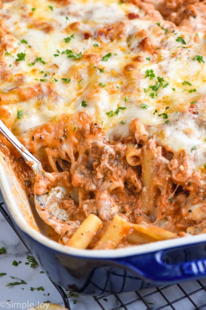 Photo of a spoon in a baking dish of Baked Ziti