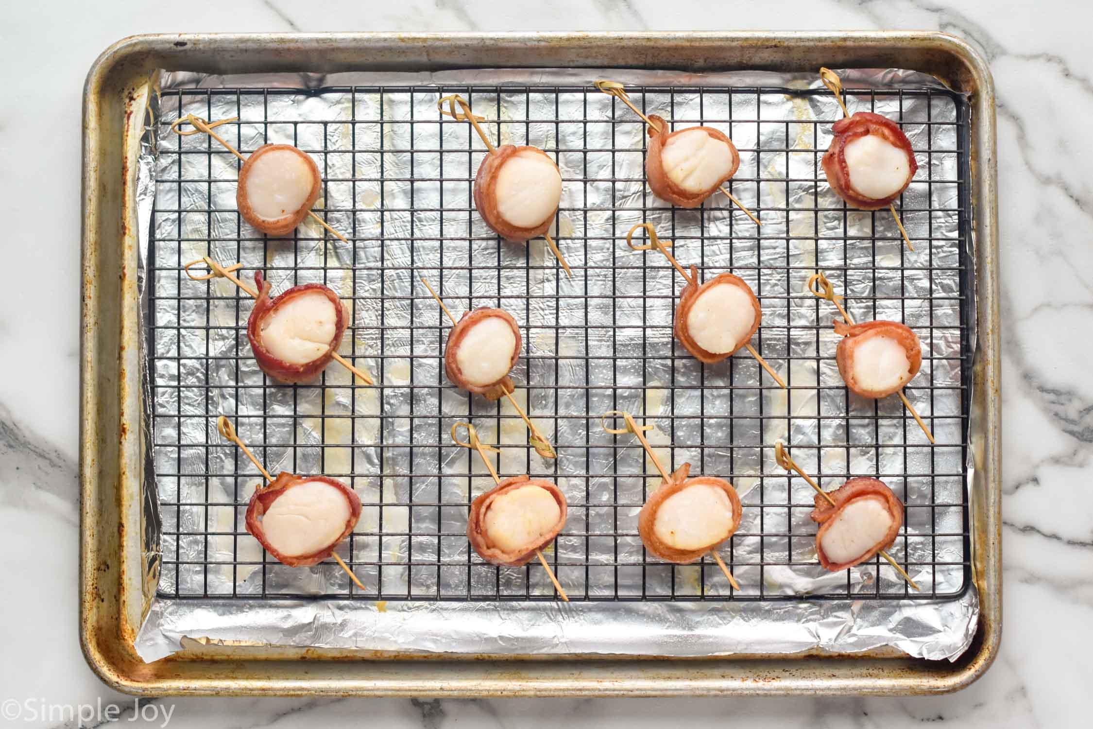 Overhead photo of Bacon Wrapped Scallops on a baking sheet