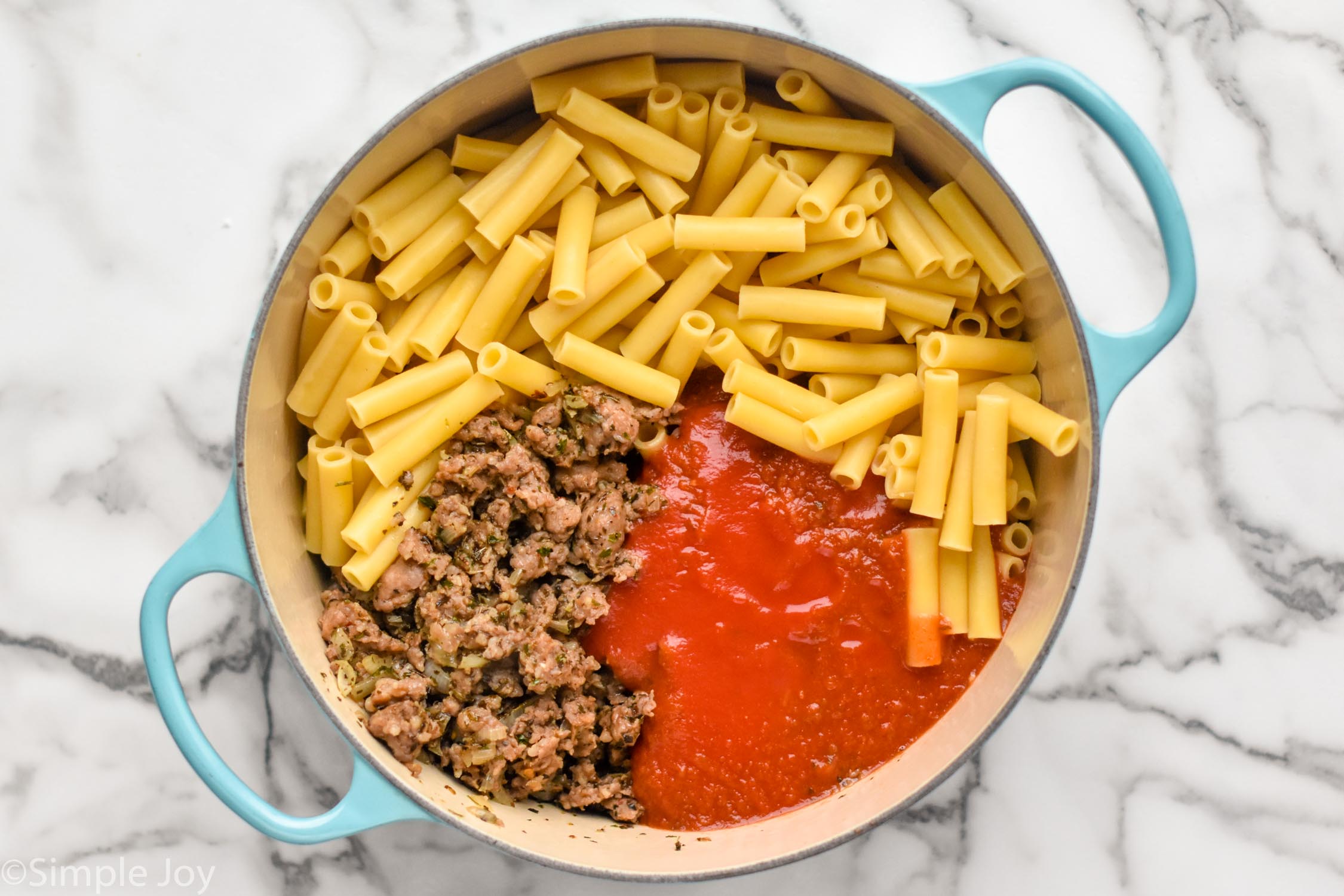 Overhead photo of a pot of ingredients for Baked Ziti recipe.