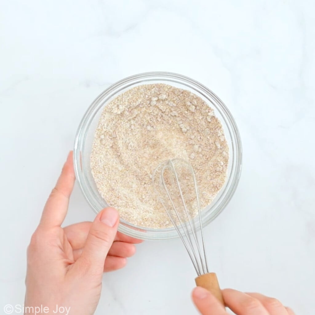 a bowl of flour cinnamon and sugar being whisked together